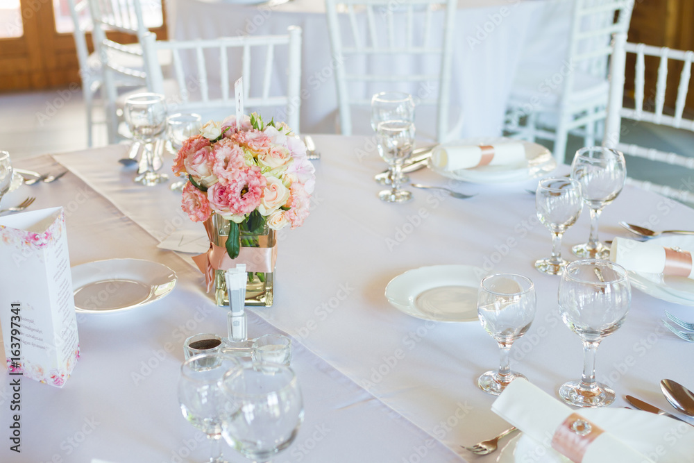 table setting with spoon, knife, plates and glass