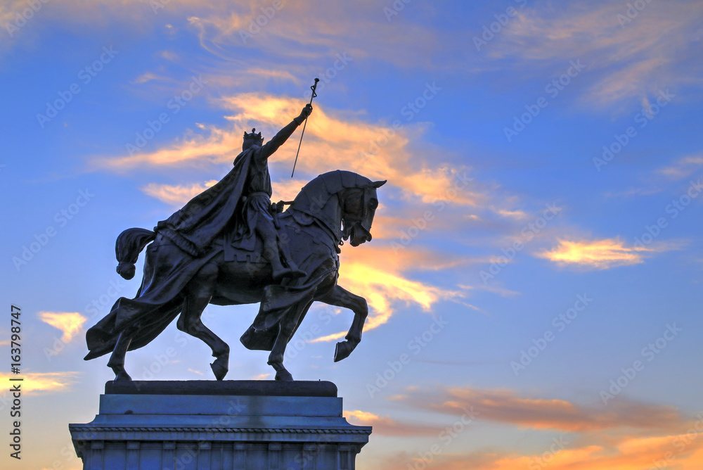 The sunset over the Apotheosis of St. Louis statue of King Louis IX of France, namesake of St. Louis, Missouri in Forest Park, St. Louis, Missouri.