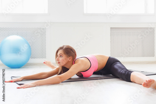 Fitness woman at stretching training indoors