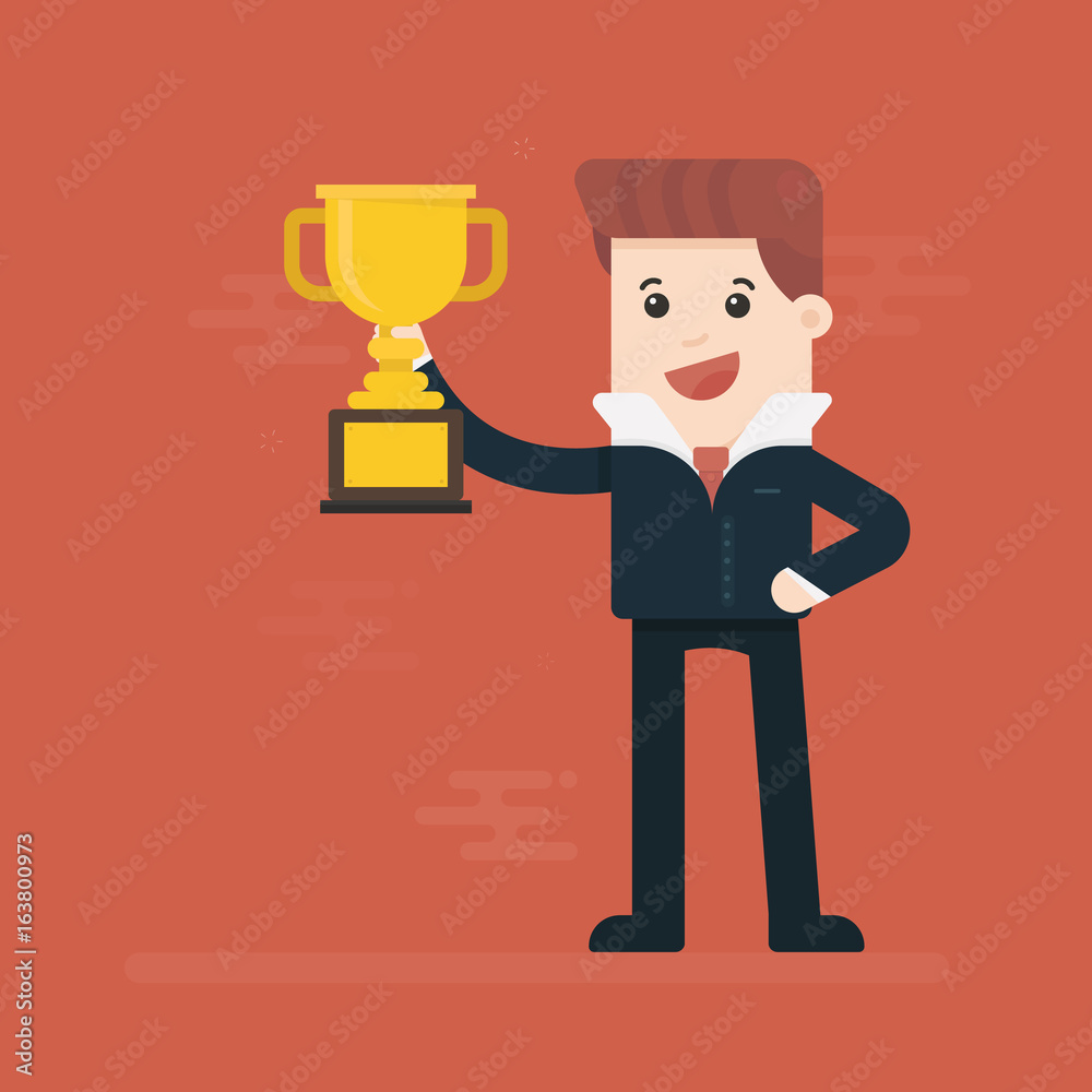 Businessman holding winning trophy