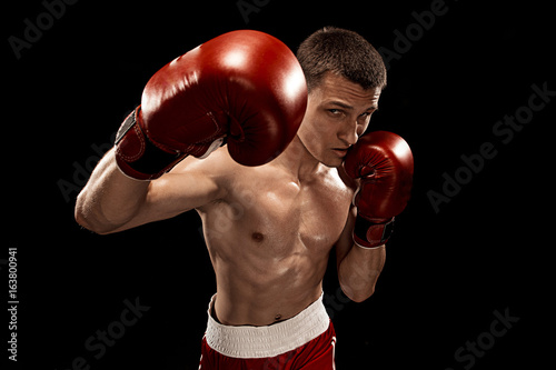 Male boxer boxing with dramatic edgy lighting in a dark studio © master1305