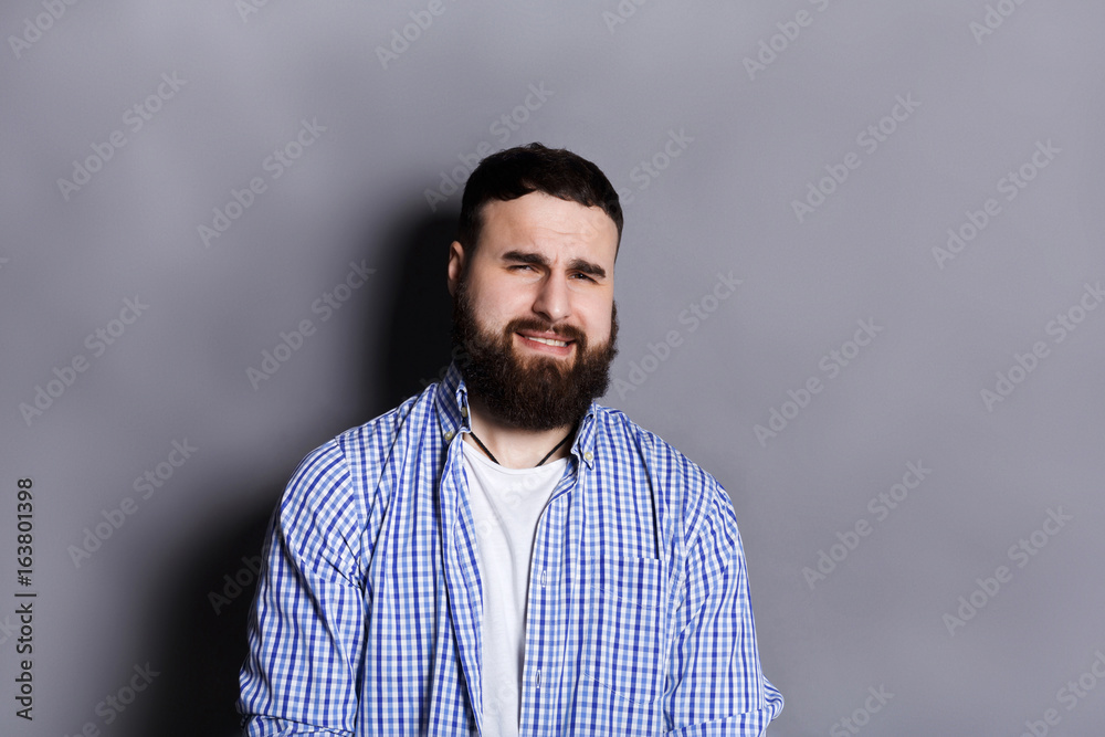 Fototapeta premium Bearded man expressing disgust, grimacing