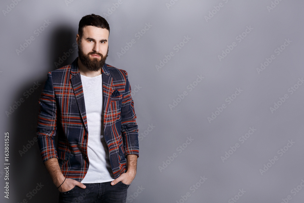 Handsome bearded man posing with hands in pocket Handsome bearded man posing with hands in pocket