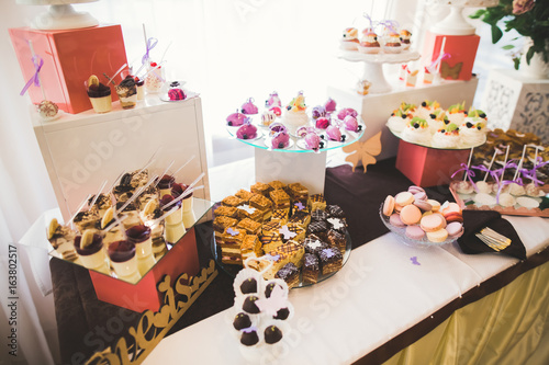Wallpaper Mural Delicious and tasty dessert table with cupcakes shots at reception closeup Torontodigital.ca