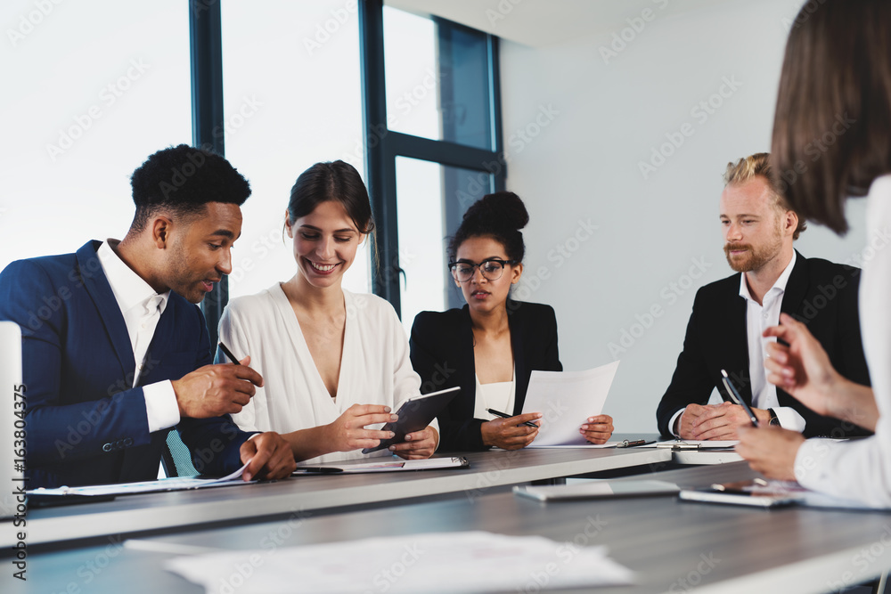 Team of businessmen work together in office. Concept of teamwork and partnership Team of businessmen work together in office. Concept of teamwork and partnership