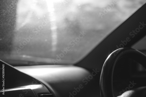 Black and white image steering wheel inside a car on the road © Farknot Architect
