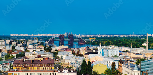 Picturesque view from Zamkova Hill of the National University Of Kyiv-Mohyla Academy, its territory and Havansky Bridge across the Dnieper river. Historical center of Kiev.