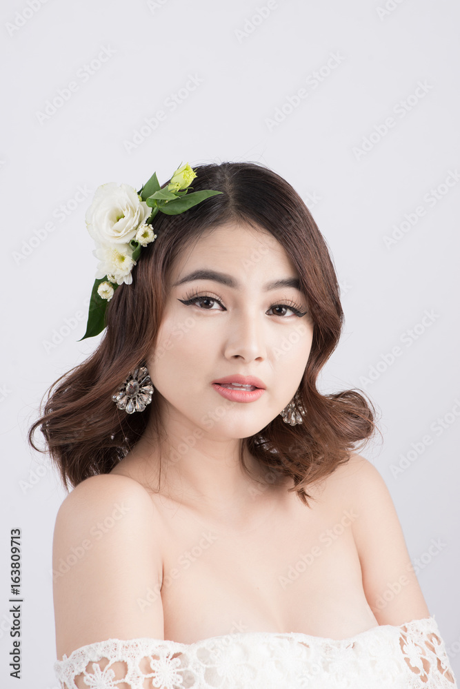 Beautiful asian woman bride on grey background. Closeup portraits with a professional makeup Beautiful asian woman bride on grey background. Closeup portraits with a professional makeup