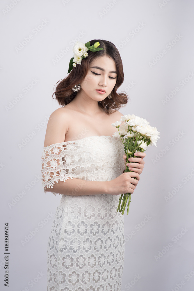 Beautiful asian woman bride on grey background. Closeup portraits with a professional makeup Beautiful asian woman bride on grey background. Closeup portraits with a professional makeup