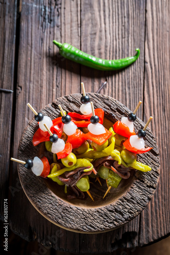 Top view of banderillas with peppers, olives and anchovies photo