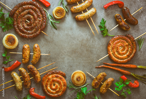 Fototapeta Naklejka Na Ścianę i Meble -  Spicy grilled sausages background