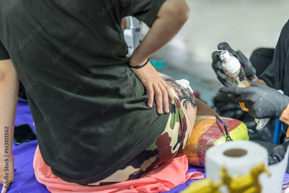 Tattoo artist drawing art on body Tattoo artist drawing art on body