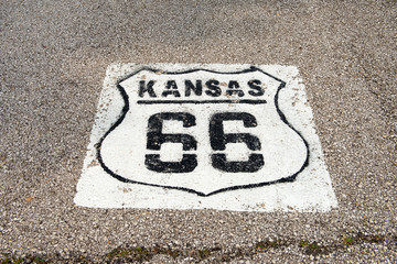 Acrylglasbilder Route 66 Historic Route 66 marker in Kansas on asphalt  © idoerenberg