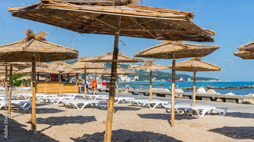 Black sea  sand beach with straw umbrellas and white sun chairs  Balchik  Bulgaria