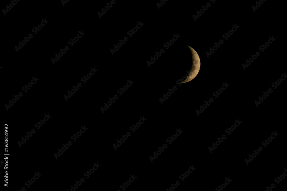 Obraz premium Waxing Crescent phase of the Moon in the black sky background