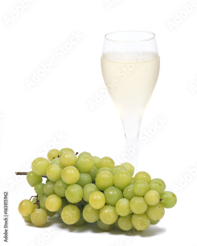 Glass of white wine and ripe organic green grapes isolated on white background
