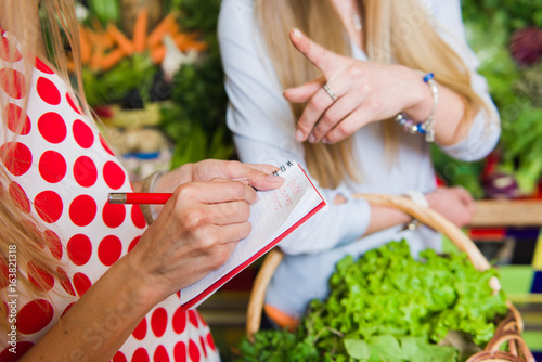 Young woman checking purchases list photo