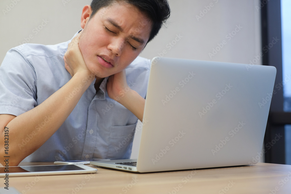 close up asian employee man massage his neck cause from work hard,unhealthy life style people, office syndrome concept close up asian employee man massage his neck cause from work hard,unhealthy life style people, office syndrome concept