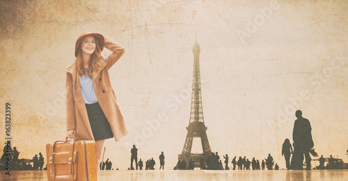 Redhead girl with suitcase and Eiffel tower © Masson