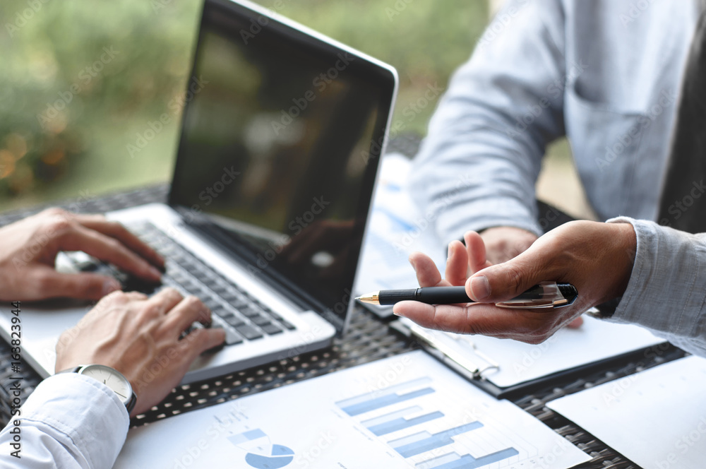 Business Executives discussing about sales performance at a modern outdoor workplace. Business Executives discussing about sales performance at a modern outdoor workplace.