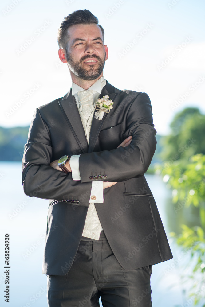 Naklejka premium Young handsome groom portrait in nature