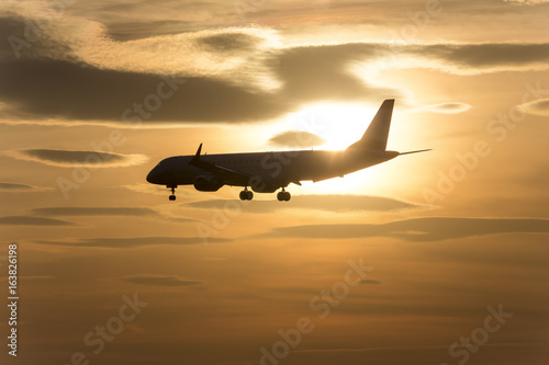 passenger airplane in front of a sundown