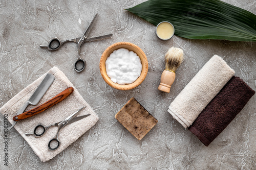 Fototapeta Naklejka Na Ścianę i Meble -  Preparing for men shaving. Shaving brush, razor, foam, sciccors on grey stone table background top view