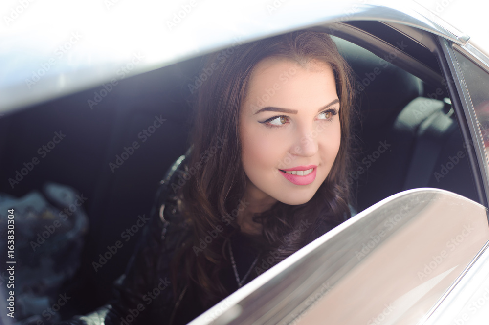 Portrait of young woman in love in a car