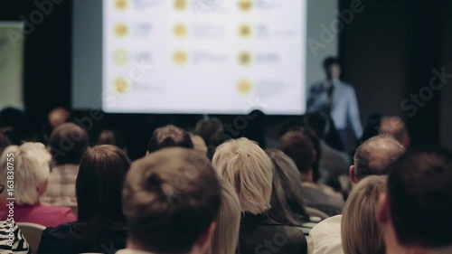 Speakers on the stage with Rear view of Audience in the conference hall or seminar meeting, business and education concept