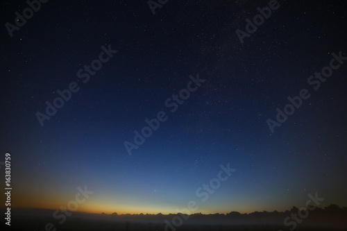 Stars of the Milky Way galaxy in the night sky. Space in the background of the morning dawn.