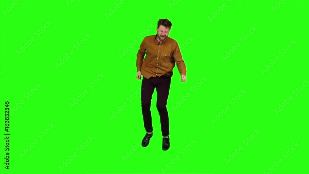 Guy jumps on the spot, he's having a good time. Green screen. Slow motion Guy jumps on the spot, he's having a good time. Green screen. Slow motion