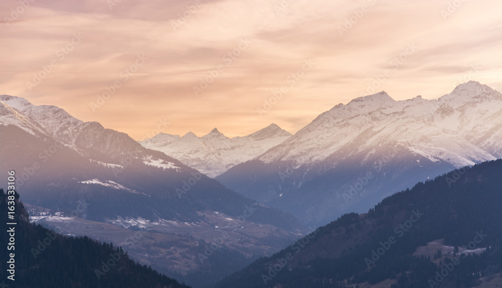 Sunset over snowy Swiss mountains