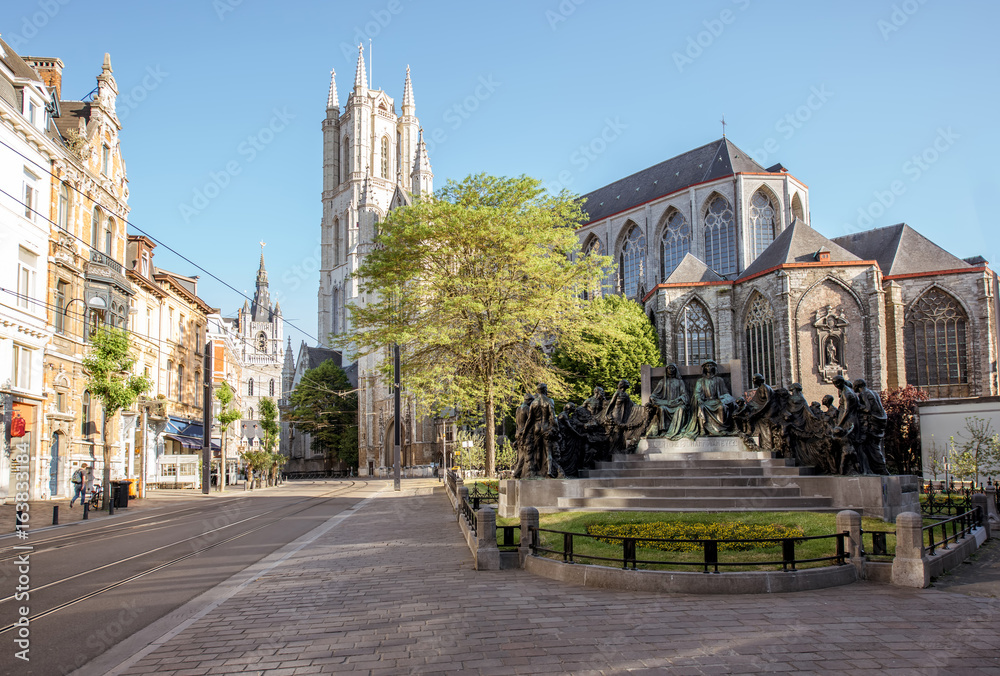 Fototapeta premium Street view with saint Bavo cathedral during the morning light in Gent city, Belgium