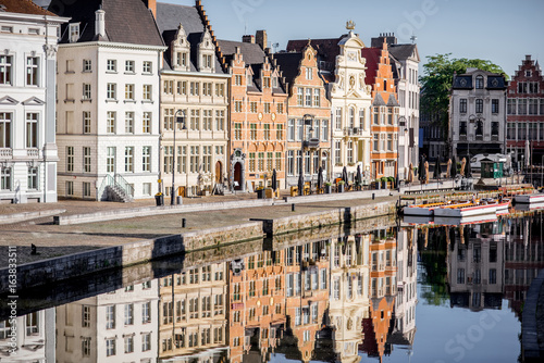 Riverside view with beautiful old buildings and water channel during the morning light in Gent city, Belgium
