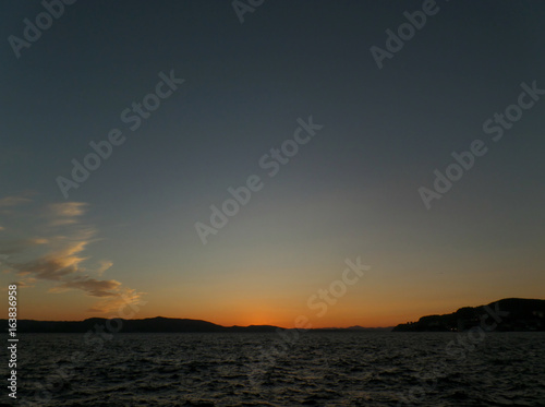 Deep Blue and Orange Norwegian Sunset Sky over the North Sea in Bergen, Norway  © jobi_pro