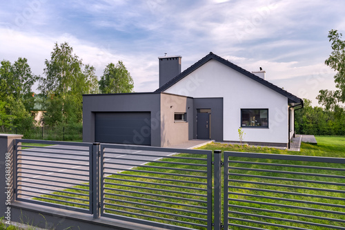 Obraz na płótnie Villa with fence and garage