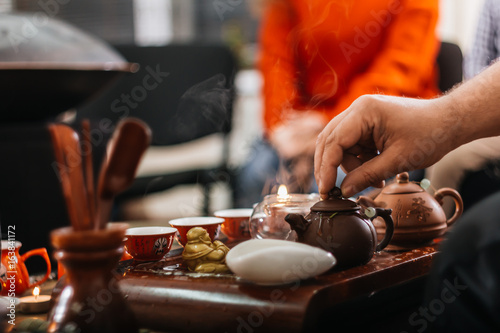 Tea ceremony. Hot chinese tea in teapots on the tea desk