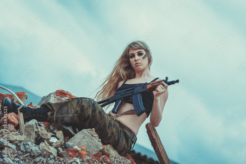 Portrait beautiful woman soldier or private military contractor with rifle.  war, army, weapon, technology and people concept Stock Photo