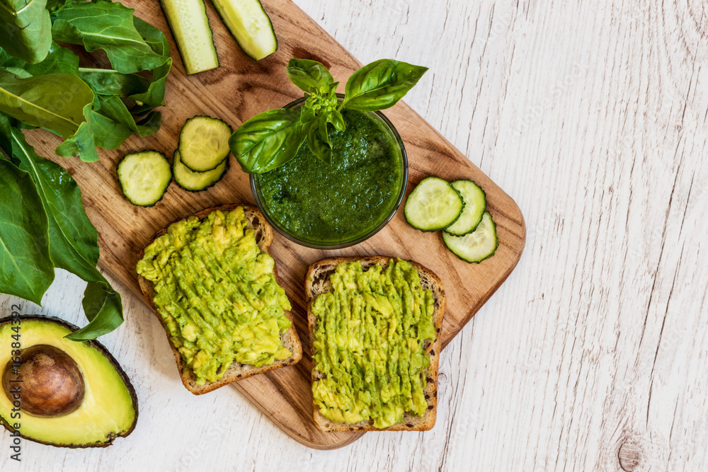 top view. green smoothie and two sandwiches with avocado. healthy vegan food top view. green smoothie and two sandwiches with avocado. healthy vegan food