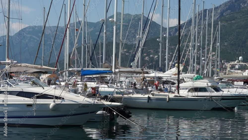 Seaside promenade in Budva, Montenegro, view of marina with boats and yachts Seaside promenade in Budva, Montenegro, view of marina with boats and yachts
