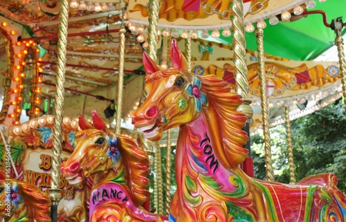 carousel merry-go-round painted horses ride - Stock Photo