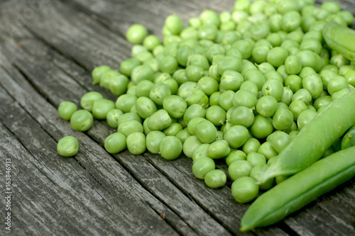Green peas on a wooden table