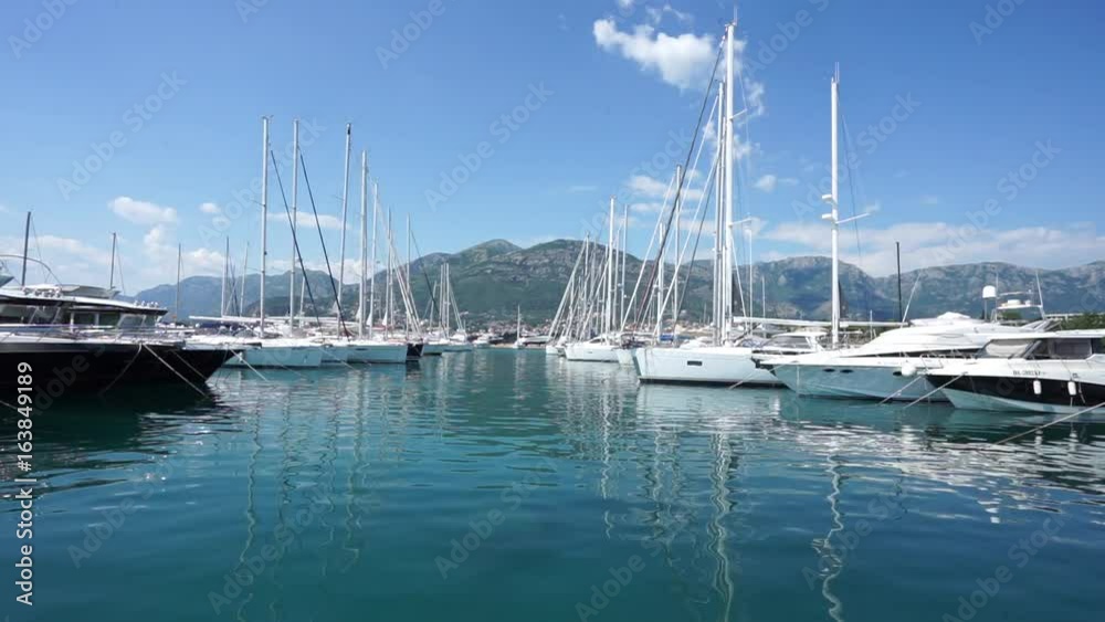 Seaside promenade in Budva, Montenegro, view of marina with boats and yachts