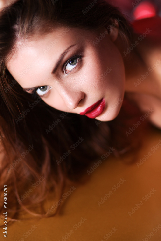 Portrait of beautiful girl with trendy makeup lying Portrait of beautiful girl with trendy makeup lying