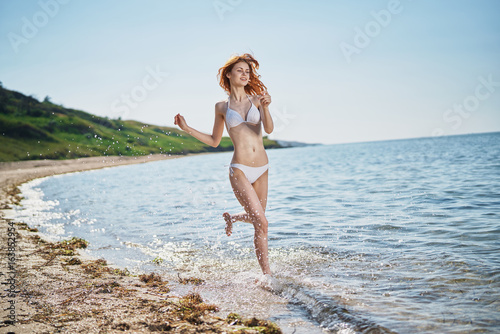Fototapeta Naklejka Na Ścianę i Meble -  Beautiful young woman resting on the sea, ocean, beach, summer, sun