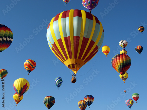 Colorful Hot Air Ballons Fly in a Clear Blue Sky