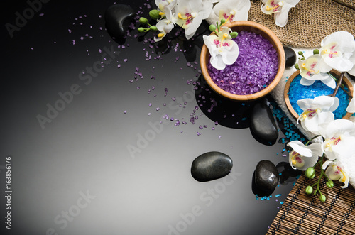 Spa concept background on black reflective background. Top view frame product photograph with copy space. Concept photograph with room for text or advertising.