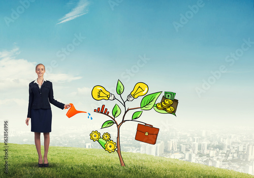 Young businesswoman outdoors watering drawn growth concept with can