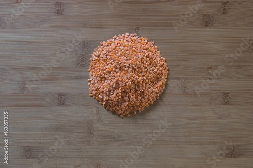 Red lentils on wooden cutting board