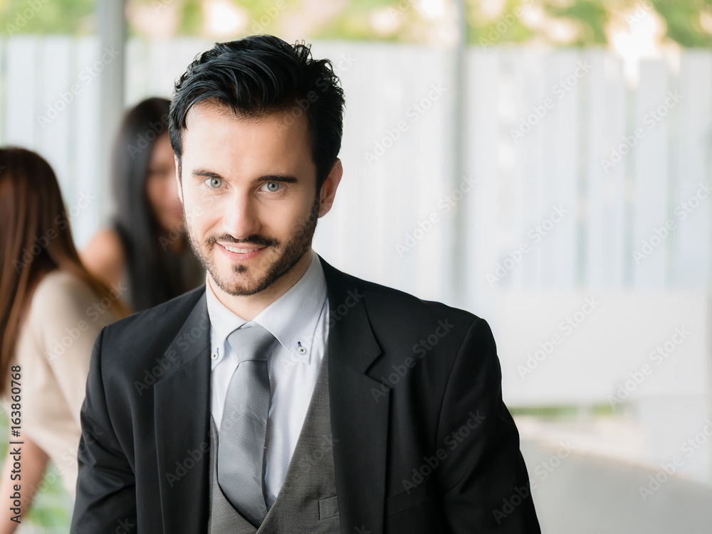Happy businessman looking at the camera,office worker,business decisions in office building Happy businessman looking at the camera,office worker,business decisions in office building